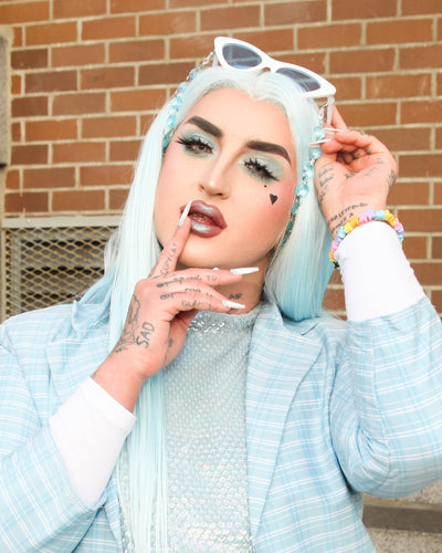 ilona in a powder blue suit, blue wig, white shades & blue lenses with the "sky" sauce strap